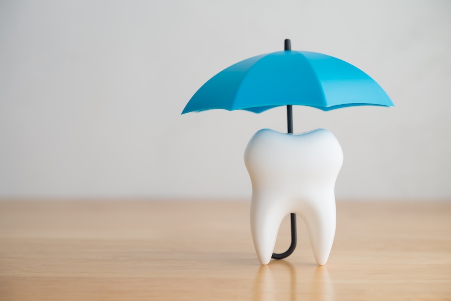 dental membership plan, tooth with blue umbrella over it