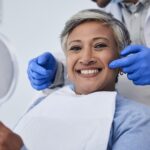 woman smiling in dental chair after cosmetic treatment, cosmetic dental treatment