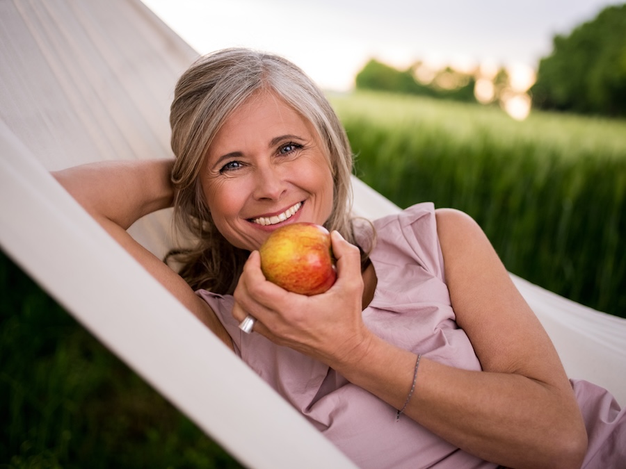 woman eating apple a healthy food for your teeth